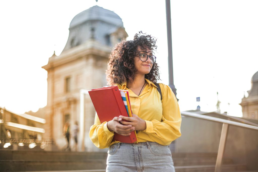 pexels-photo-3762800-3762800 Woman In Yellow Jacket Holding Books