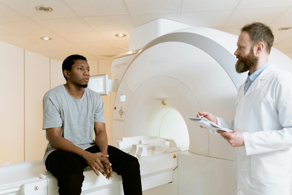 pexels-photo-7088488-7088488 A doctor discusses MRI results with a patient in a hospital setting.